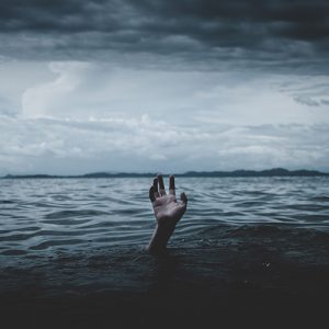 photo of a hand sticking out of water