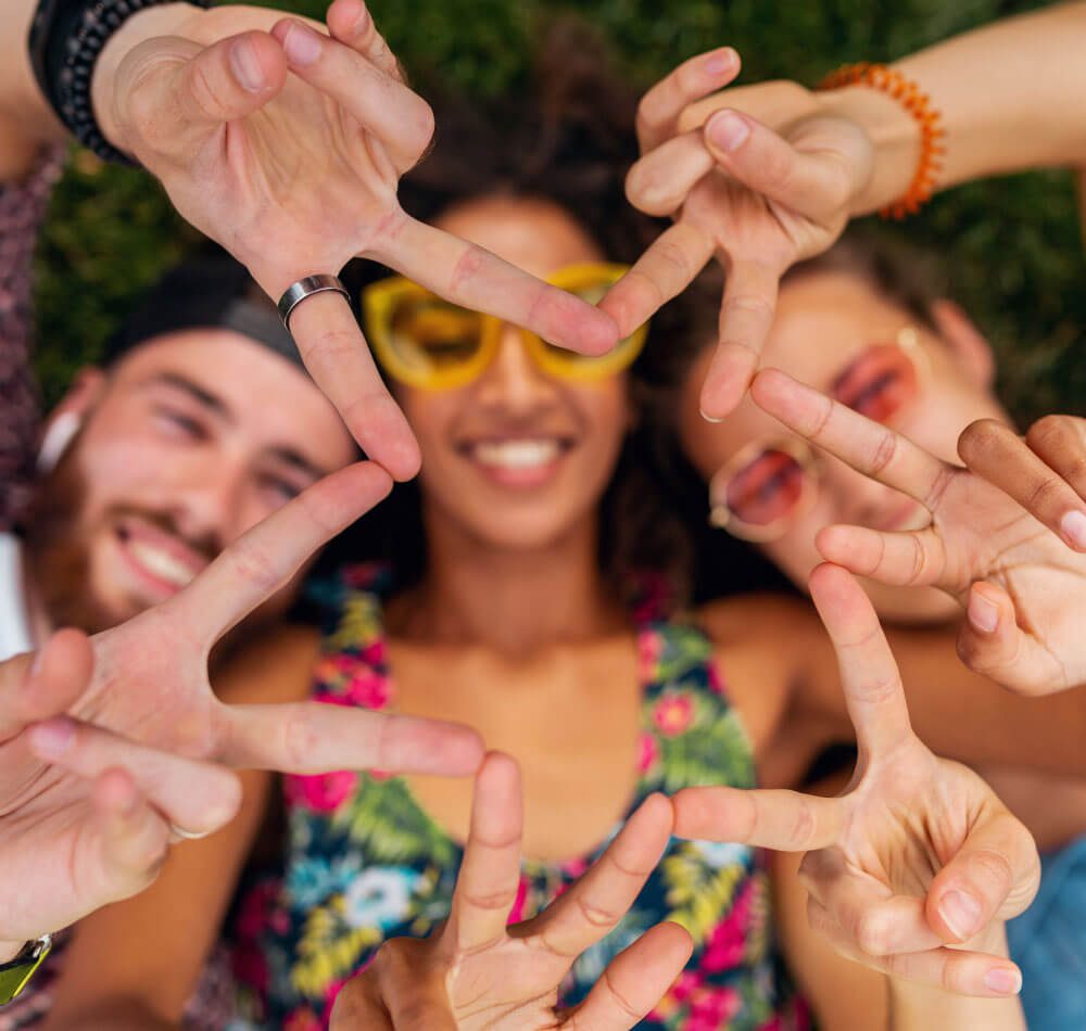 A group of people are making a peace sign with their hands