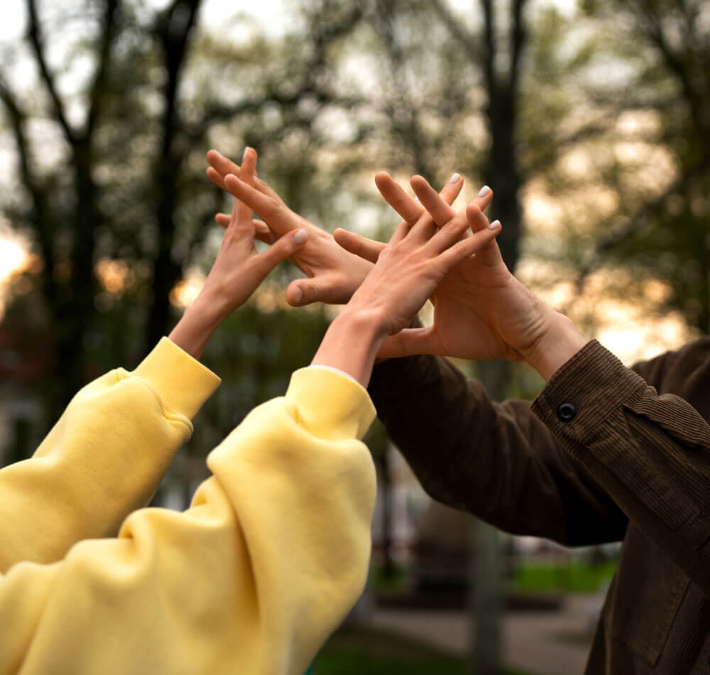 Two people giving each other a high five with their hands